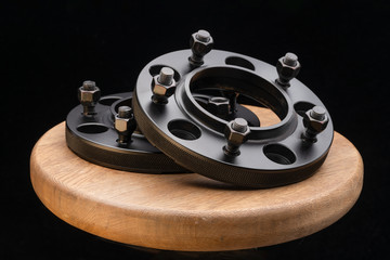 Automotive parts - close up new stainless black metal remote adapter spacer wheel hub of the car on...