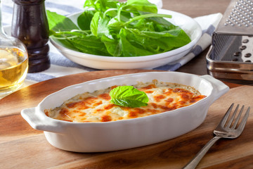 Baked spinach with cheese on a wooden background