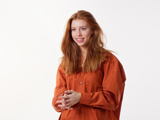 young girl with loose long red hair on a white background
