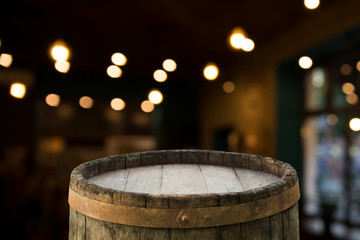 Oktoberfest beer barrel and beer glasses with wheat and hops on wooden table