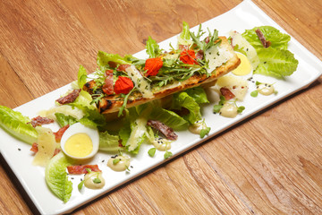 Chicken Caesar salad. Exquisite dish. Creative restaurant meal concept.	