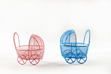 Miniature prams on a white background close-up. Baby and pregnancy concept and copy space. Baby...