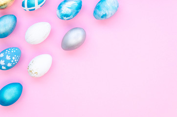 Stylish Easter Corner Frame background with silver and blue easter eggs on pink background. Mockup, top view