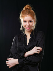 young girl with long red hair on a black background