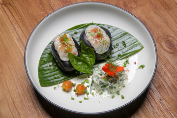 Sea scallop on frozen stone with cucumber spaghetti and citrus dressing. Exquisite dish. Creative restaurant meal concept.	