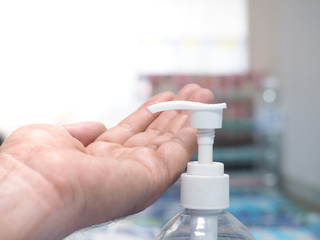 hand with pills and pill bottle of water