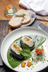 Sea scallop on frozen stone with cucumber spaghetti and citrus dressing. Exquisite dish. Creative restaurant meal concept.	