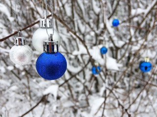 Blue and silver Christmas balls on defocused background. Copy space, winter background