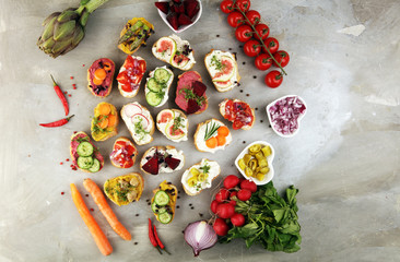 Assorted bruschetta with various toppings. Appetizing bruschetta or brie crostini. Variety of small...