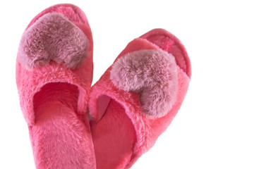 Pink home fluffy slippers on a white background