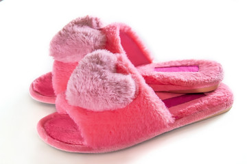 Pink home fluffy slippers on a white background