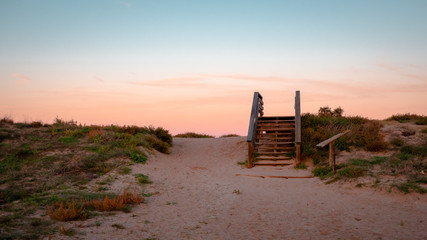 Wild beach with sandy dunes at sunset by the Mediterranean Sea in Valencia Spain