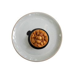 Top view of macadamia cheese cake topped with caramel sauce. Nut and almond bakery pastries isolated with clipping path.