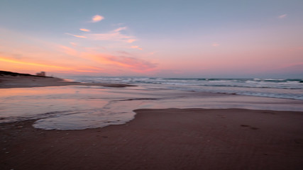 Fototapeta na wymiar Wild beach with sandy dunes at sunset by the Mediterranean Sea in Valencia Spain