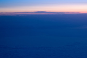 Fototapeta na wymiar Beautiful view of sunset sky above clouds from airplane.