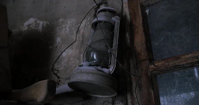 Old lamp Oil lantern hanging on a wall in a garage.