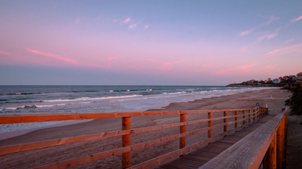 Fototapeta premium Wild beach with sandy dunes at sunset by the Mediterranean Sea in Valencia Spain