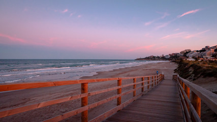 Obraz premium Wild beach with sandy dunes at sunset by the Mediterranean Sea in Valencia Spain
