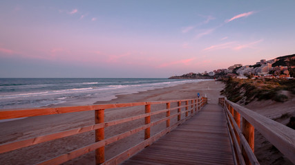 Obraz premium Wild beach with sandy dunes at sunset by the Mediterranean Sea in Valencia Spain