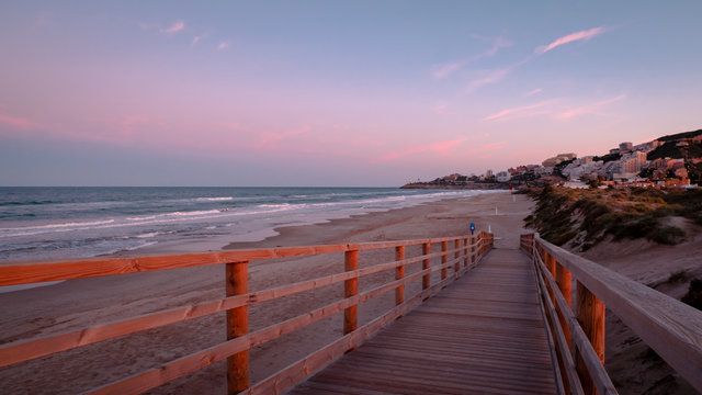Wild beach with sandy dunes at sunset by the Mediterranean Sea in Valencia Spain