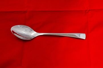 spoon isolated on red background