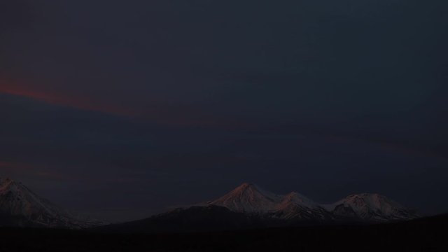 Timelapse Sunset of the volcano. Sunshine over high mountain peak. Timelapse Movie of Beautiful Sunset Scene Mountain . Sunset over volcano with stars in the night sky. 4K