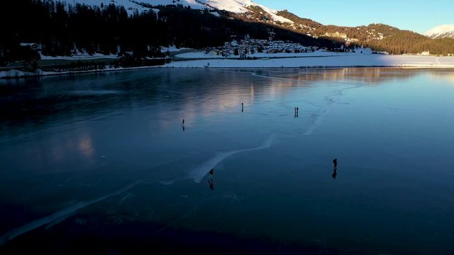 St Moritz Engadin valley Switzerland - winter iced lake skating on ice - aerial view