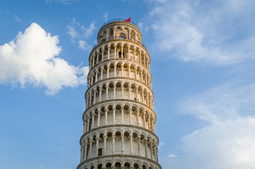 Pisa tower close view and light clouds at blue sky. Pisa, Italy.
