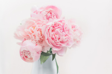 Bouquet of pink peonies in a vase pastel toned.