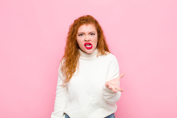 young red head woman looking angry, annoyed and frustrated screaming wtf or what‚Äôs wrong with...