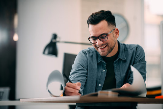 Young businessman working on project. Handsome architect in office.  