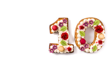 Number ten cake decorated with flowers  and macarons isolated on white background.Copy space	