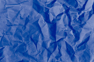 Picture of the blank dark blue crumpled and creased paper, poster texture background with copy space