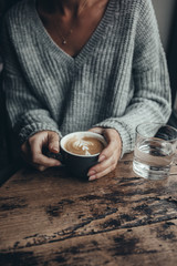 young woman holding a cup