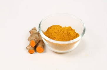 Curcuma. Turmeric powder in glass cups and fresh turmeric isolated on a white background. Used as a tonic for the body and food ingredients.