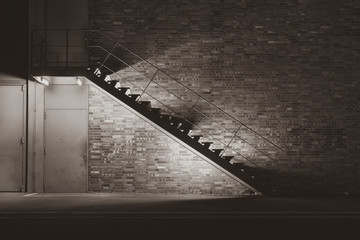 illuminated metal stair at night, simple stairway at night, black and white photo, silky contrast, sepia