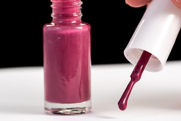 red nail polish and manicure brush with varnish