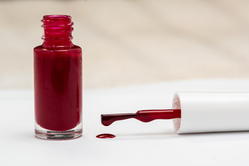 red nail polish and manicure brush with varnish