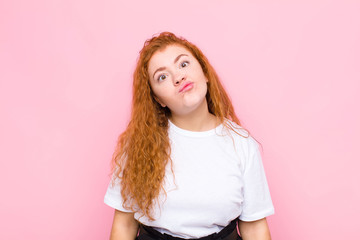 young red head woman looking goofy and funny with a silly cross-eyed expression, joking and fooling...