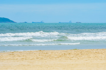 Beach on a beautiful sunny day. Sand and the waves of the sea of Enseada beach - Guaruja SP Brazil.