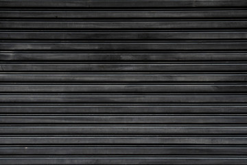Rolling shutters painted with old black for background and textured.
