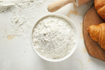 Bowl with flour on table