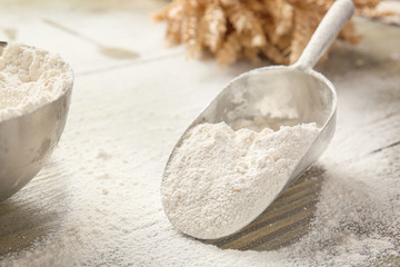 Scoop with fresh flour on table