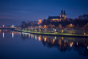 Fototapeta na wymiar Night city landscape. The Vistula River at night in Krakow, Poland.