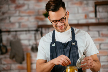 Young man cooking pasta. Chef preparing pasta in modern kitchen	
