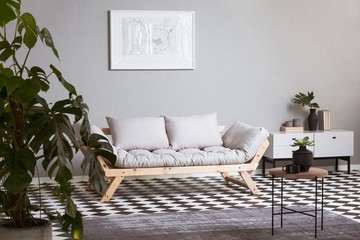 White map on grey wall in fashionable living room interior with scandinavian futon