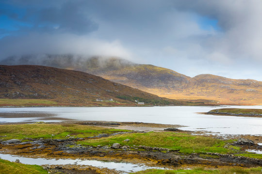Tranquil scene clouds over rolling hills lake, Loch Aineort, South Uist, Outer Hebrides