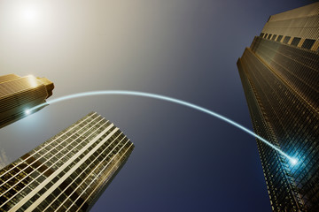 Fiber optic light trail communication connecting highrise buildings, concept
