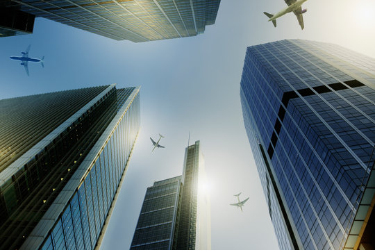 Airplanes flying over highrise buildings, travel concept