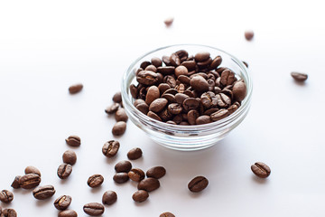 Roasted Coffee beans close up on the white table. 